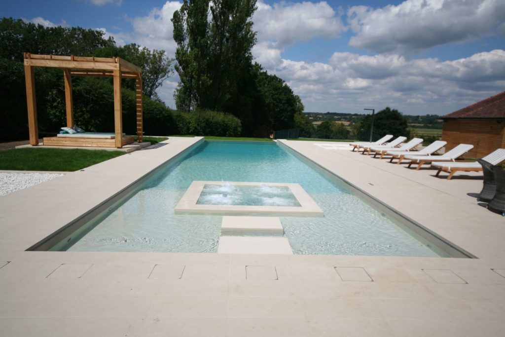 Infinity Pool with Internal spa, shallow beach area and stepping stones to the spa pool with muted tones gives this pool and spa an L.A vibe.