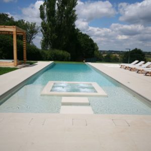 Infinity Pool with Internal spa, shallow beach area and stepping stones to the spa pool with muted tones gives this pool and spa an L.A vibe.