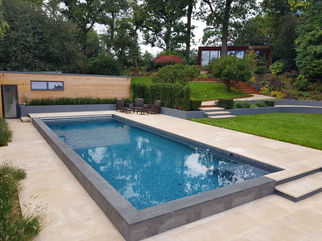 Raised walls to this London outdoor pool with black fittings and automatic cover