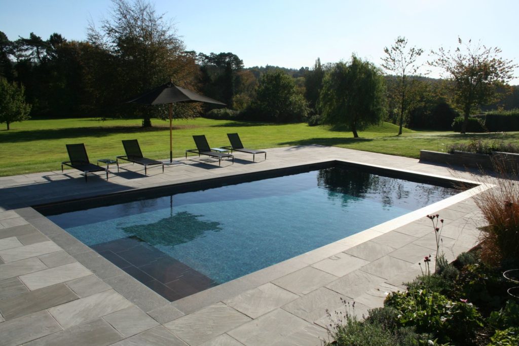 Country garden pool with charcoal mosaics, slate steps and copings