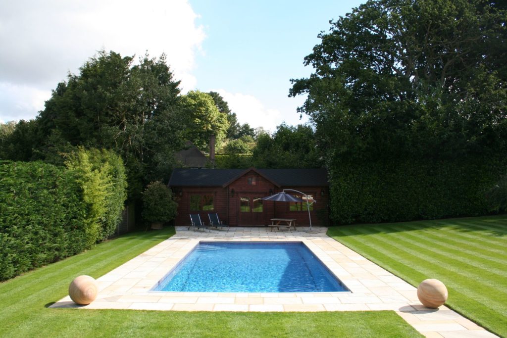 Classical blue mosaics in this Surrey garden pool with an automatic safety cover