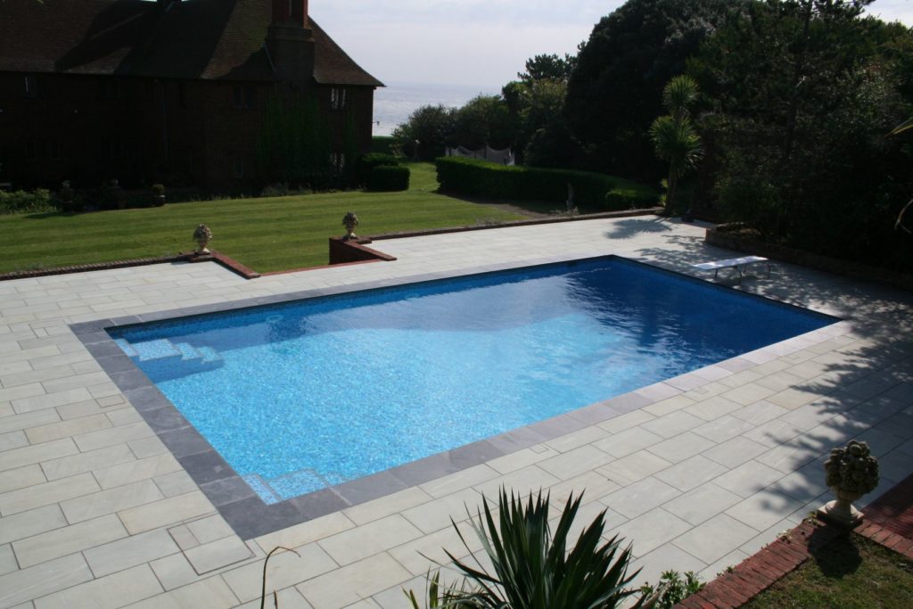 Family fun mosaic pool with double steps, diving board and an automatic safety cover