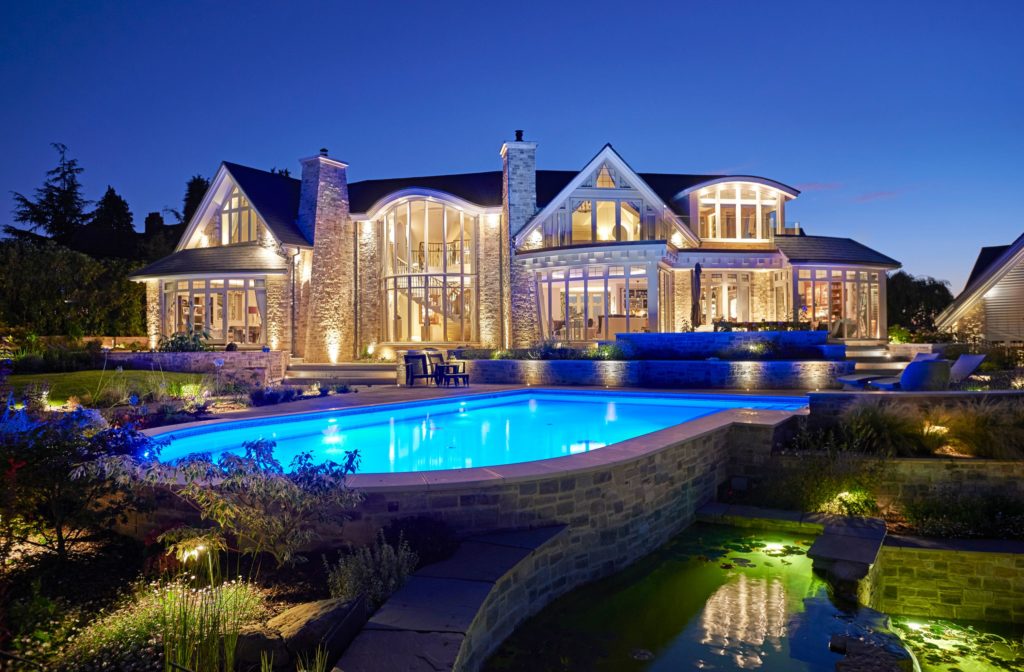 SPATA British Outstanding Pool of the Year 2020 built into multi level terracing surrounded by waterfalling koi ponds with jetted lounging step area and automatic slatted cover