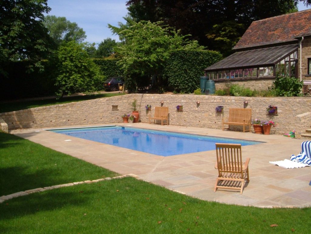 Cut into the hillside to create a pool terrace this simple outdoor pool is perfect for the entire family