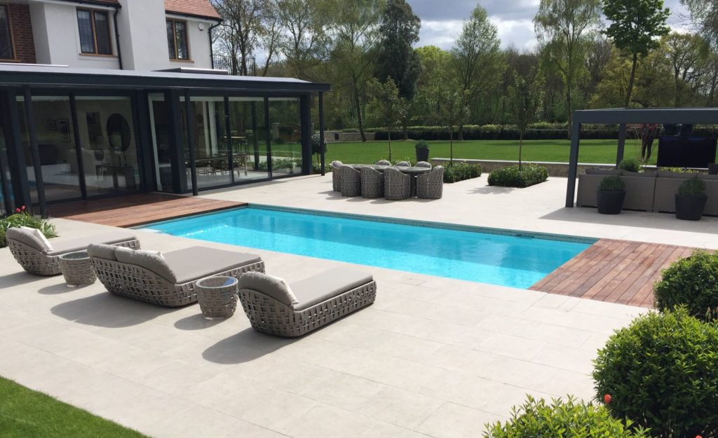 Contemporary outdoor pool with automatic cover in this country garden