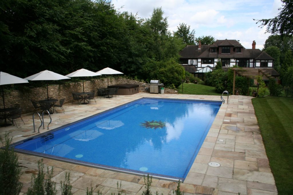 Plenty of space for entertaining around this large family pool in blue mosaic tiles